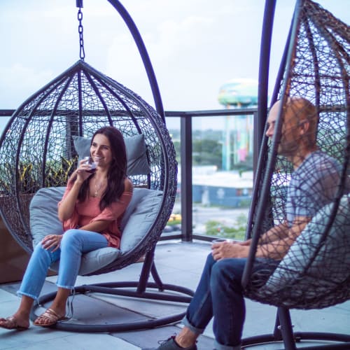 Residents chatting in hanging chairs at Motif in Fort Lauderdale, Florida