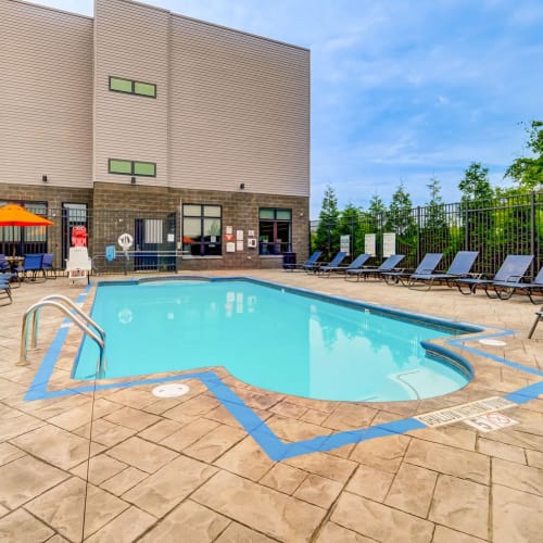 Outdoor seating and heated swimming pool at Park West 205 Apartment Homes in Pittsburgh, Pennsylvania