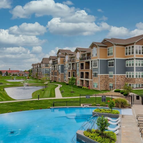 Resort-style pool and lush green lawn at The Residences at New Longview in Lees Summit, Missouri