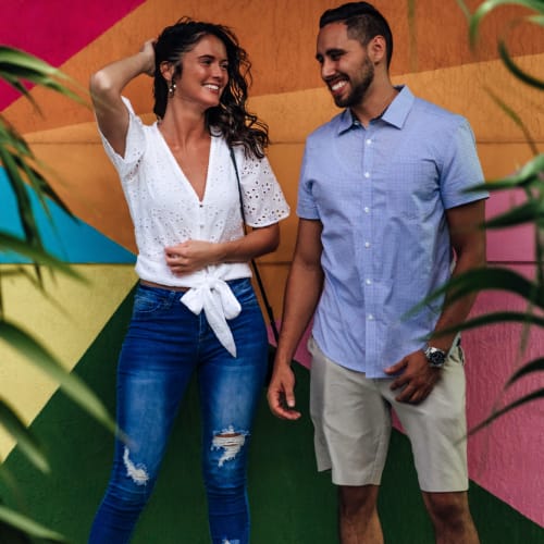 Residents standing in front of a colorful mural at Motif in Fort Lauderdale, Florida