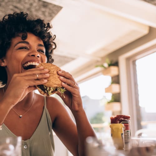 Resident enjoying a burger nearby Mariner's Pointe in Joppatowne, Maryland