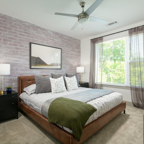 Model bedroom with green accents at Quill in Atlanta, Georgia