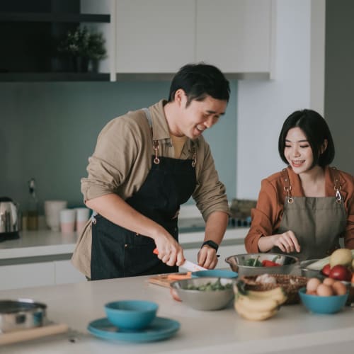 A couple preparing a meal in a loft kitchen at Theatre Lofts in Birmingham, Alabama