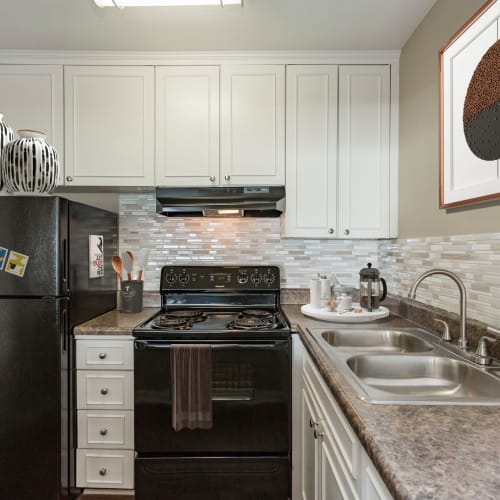 Kitchen with black appliances at Belmont Place Apartments in Nashville, Tennessee