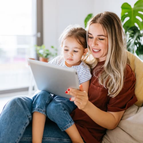 Resident reading to her daughter from a tablet at Harborstone in Newport News, Virginia