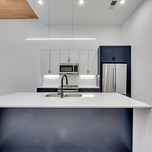 A modern kitchen with center island in a loft apartment at Theatre Lofts in Birmingham, Alabama