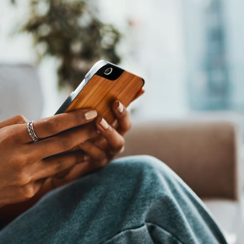 Resident checking her phone at Aston Pointe Apartments in Aston, Pennsylvania