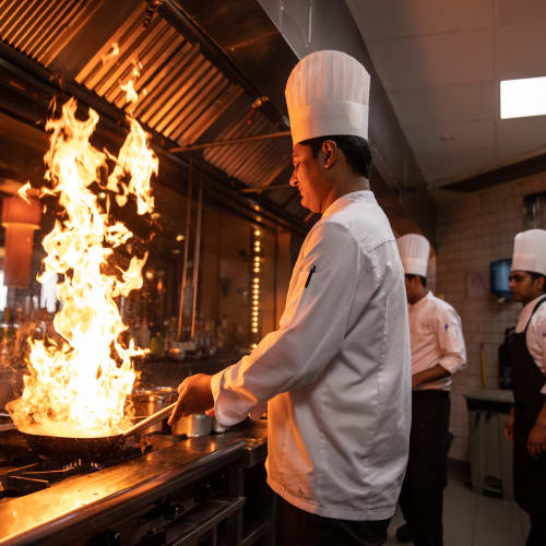 On site chef cooking with fire at All Seasons Rochester Hills in Rochester Hills, Michigan
