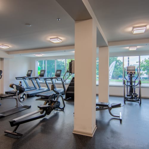 A row of treadmills and rowing machines in the fitness center at Innslake Place in Glen Allen, Virginia