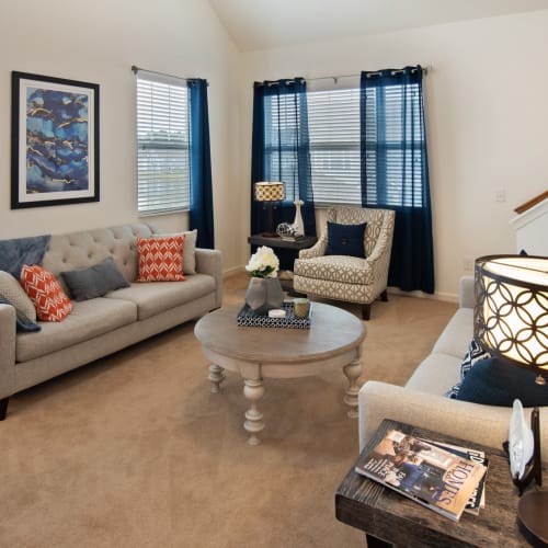 A furnished living room in an apartment at Cottages at Emerald Cove in Savannah, Georgia