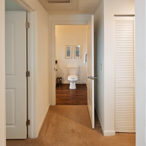 A hallway to a bathroom in an apartment at Cottages at Emerald Cove in Savannah, Georgia
