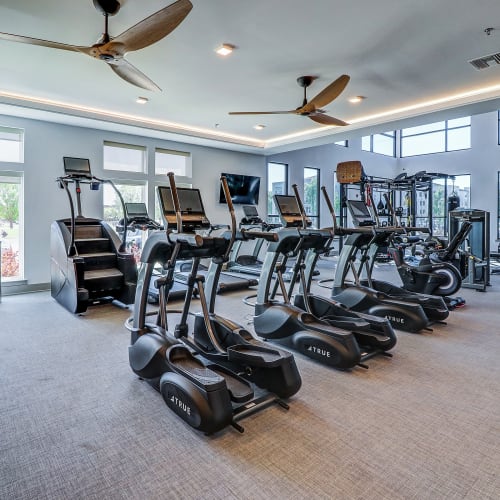 Fitness room equipped with cross trainer machines, cycles, treadmills and ceiling fans at Mosby Bridge Street in Huntsville, Alabama