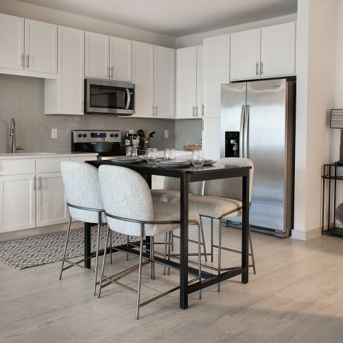 An apartment kitchen and dining room at The Station at Fleming Island in Fleming Island, Florida