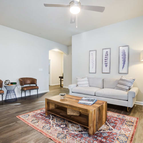 Wood flooring and a ceiling fan in a furnished living room at North Hills at Town Center in Raleigh, North Carolina