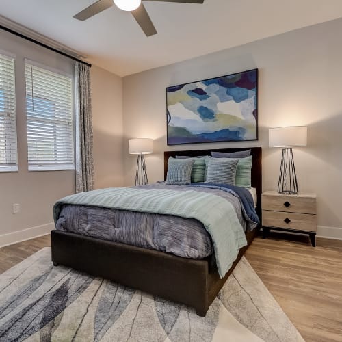 Wood flooring and a ceiling fan in an apartment bedroom at Mallory Square at Lake Nona in Orlando, Florida