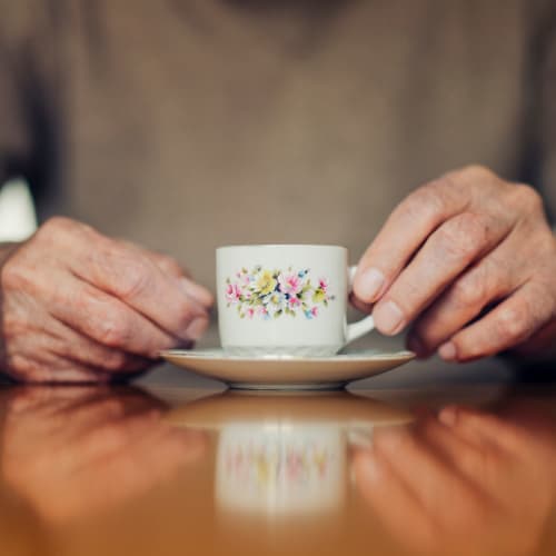 Resident with a cup of tea at Oxford Springs Durant in Durant, Oklahoma