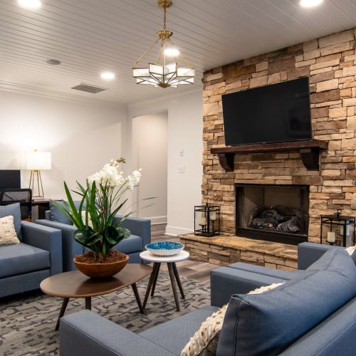 Community gathering space with a fireplace at Houston Lake Apartments in Kathleen, Georgia