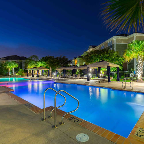 Swimming pool with modern design and great view at night at Spring Water Apartments in Virginia Beach, Virginia