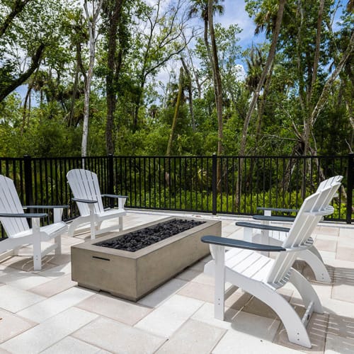 A firepit with lounge seating around it at Integra Trails in Cocoa, Florida