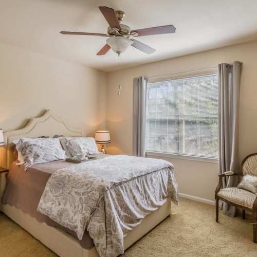 Bedroom with a large bed and a ceiling fan at Wildwood Creek in Grapevine,Texas