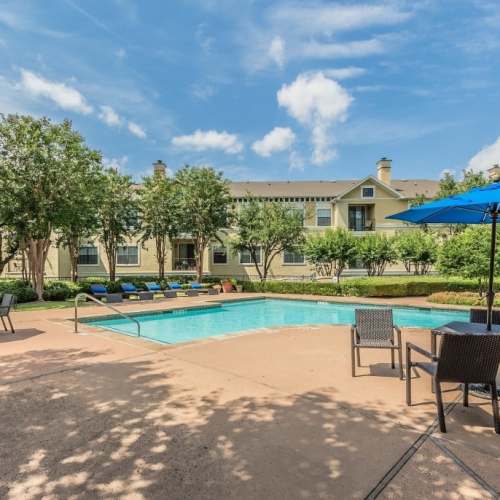 Table chairs by the swimming pool at Grand Estates at Kessler Park in Dallas, Texas