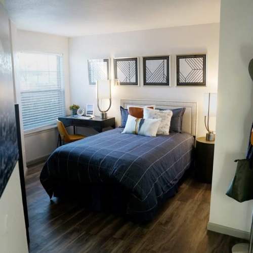 Cozy bedroom with wall arts at GrandView @ Flatirons in Louisville, Colorado