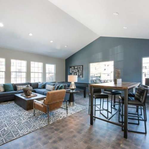 Clubhouse with couch and tables, chairs at GrandView @ Flatirons in Louisville, Colorado