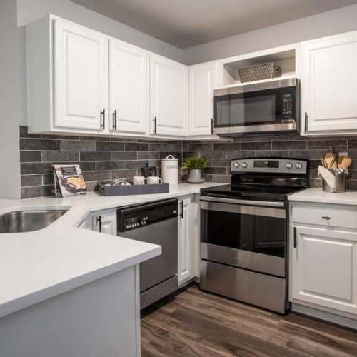 Kitchen with hardwood flooring at GrandView @ Flatirons in Louisville, Colorado