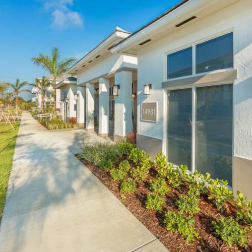 Walkway with lush greenery at The Olivia in Homestead, Florida