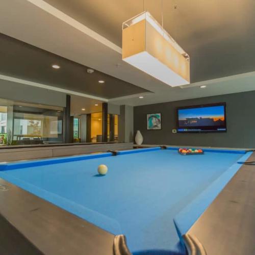 Well-lit games room with pool at Linden in Portland, Oregon