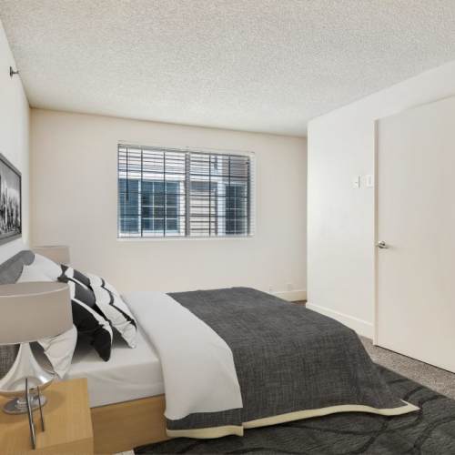 Cozy bedroom with window at Sullivan's Ridge in Portland, Oregon
