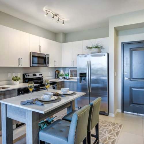 Kitchen with easy access to the dining table at Club Prado in West Miami, Florida