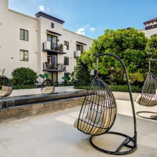 outside seating with single seater swing chair at Club Prado in West Miami, Florida