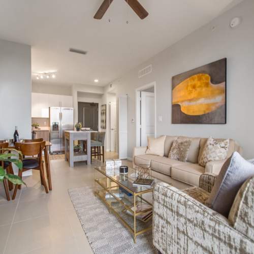 Open layout carpeted living room with plenty of room for a couch, coffee table, and more at  Club Prado in West Miami, Florida