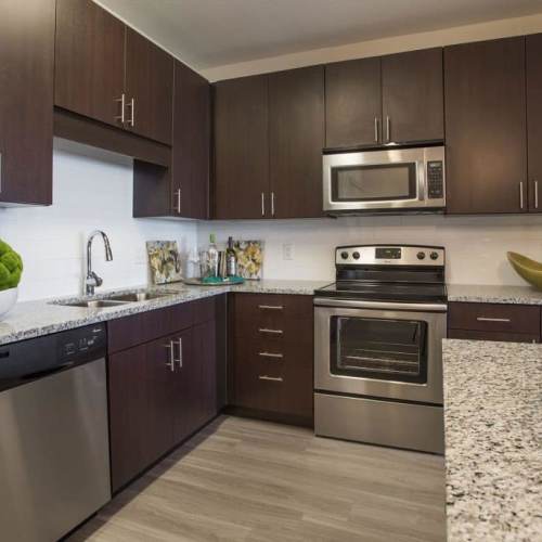 Well-equipped kitchen with granite countertops, stainless-steel appliances at Elevation @ County Line Station in Englewood, Colorado