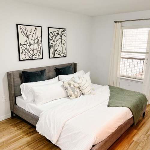 Spacious bedroom with hard-wood style flooring at Emerald Grove in Orlando, Florida, 