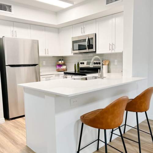 Spacious island kitchen with stainless steel appliances at Emerald Grove in Orlando, Florida, 