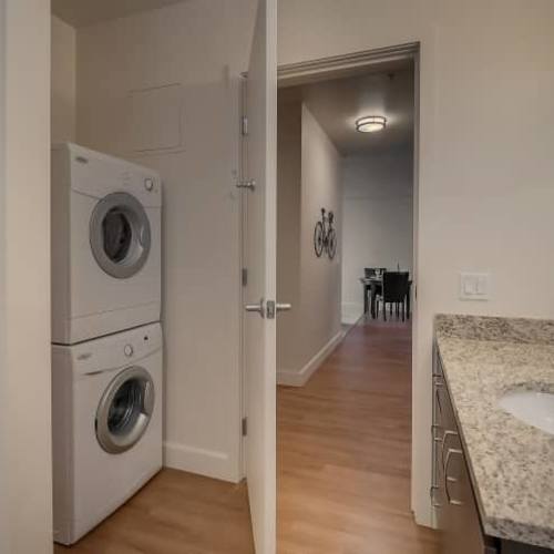 Laundry area with view to living room  at The Cameron in Portland, Oregon 