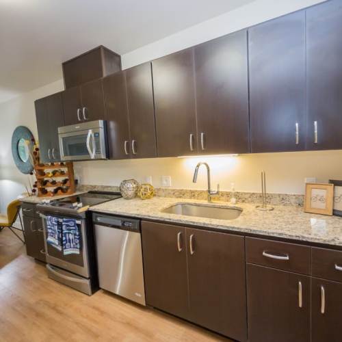 Kitchen with stainless steel appliance at The Cameron in Portland, Oregon
