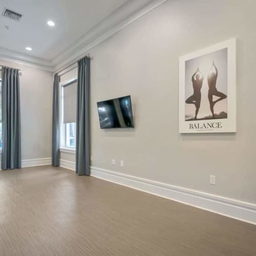 Community empty room with television at {location_name}} in Plantation, Florida