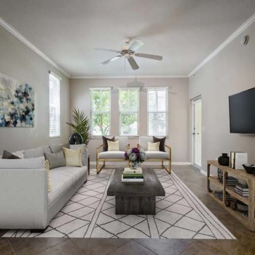 Spacious living room with large windows at {location_name}} in Plantation, Florida