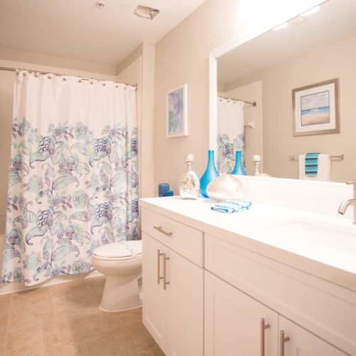 Bright bathroom with vanity lights at {location_name}} in Plantation, Florida