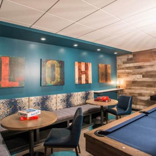 Tables and chairs by the pool table in the clubhouse at LoHi Gold in Denver, Colorado