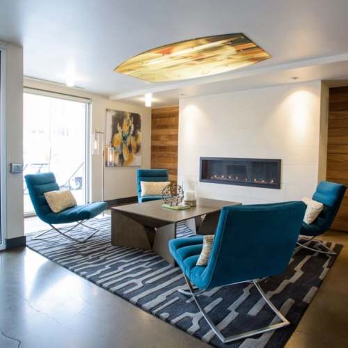 Seating by a fireplace in the lobby at LoHi Gold in Denver, Colorado