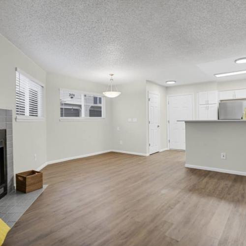 Open layout living room with hard-wood style flooring at Walker Landing in Aurora, Colorado, 