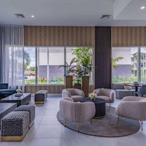 Clubhouse with large window and seating space at Palm Beach Preserve in West Palm Beach, Florida