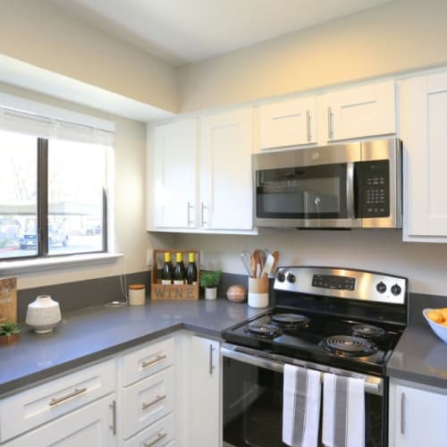 Kitchen with stainless-steel appliances at Ellington Apartments in Davis, California