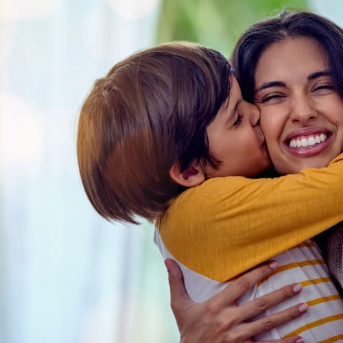 Boy kissing his mother at 1221 Vallejo Apartments in Novato, California