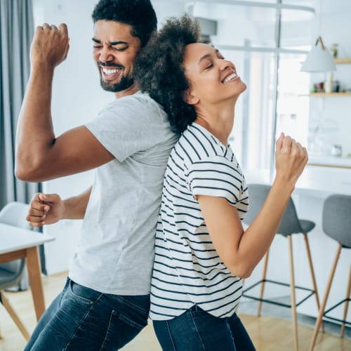 Resident couple dancing in their apartment at Brio Parc in Madison, Alabama