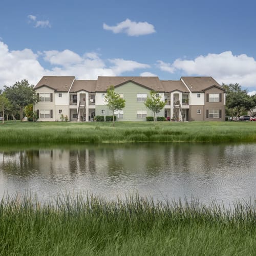 The community pond with apartments on the other side at Vero Green in Vero Beach, Florida